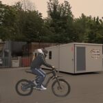 16 year old boy arrives at Hammersmith poling station by electric bike in 2024